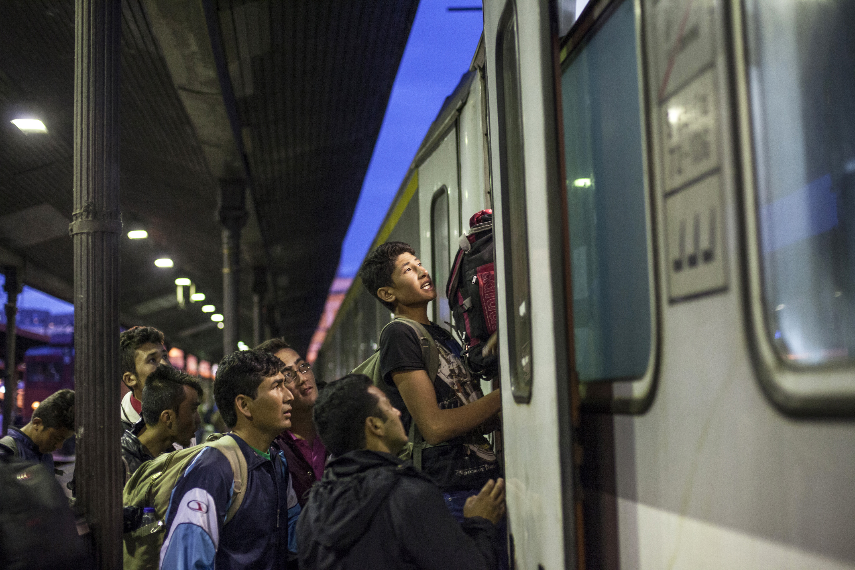 Train overcrowded with refugees at the main Belgrade station is unable to start scheduled journey towards city of Subotica near border with Hundary because there are still people outside attempting to get on aboard.25.06.2015 Belgrade, Serbia